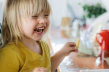 HAPPY KID EATING FRIES